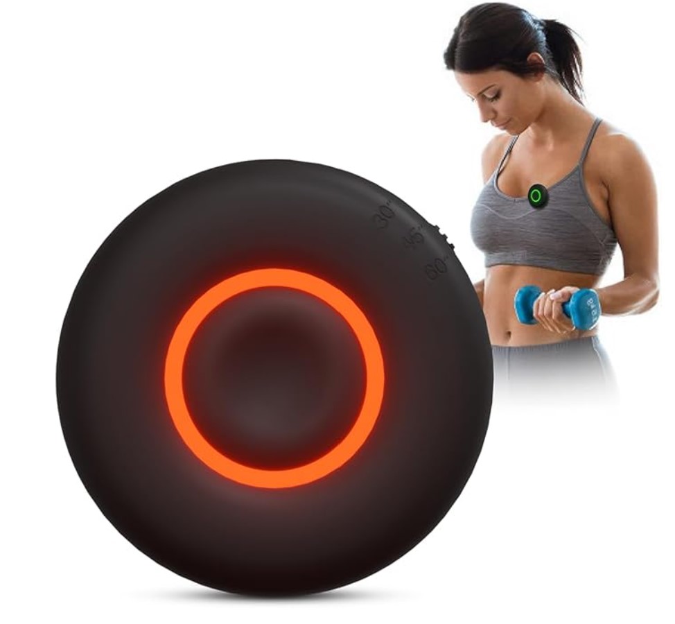 In the foreground, Black round device with red, glowing ring in the middle. In the background a women lifting a hand weight wearing the timer on her sports bra