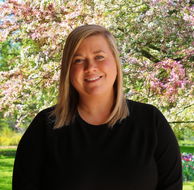 Image of Jenna Trager. Lady with black shirt and blonde hair smiling
