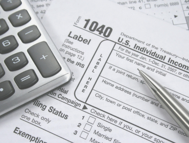 image of tax form, pen and calculator