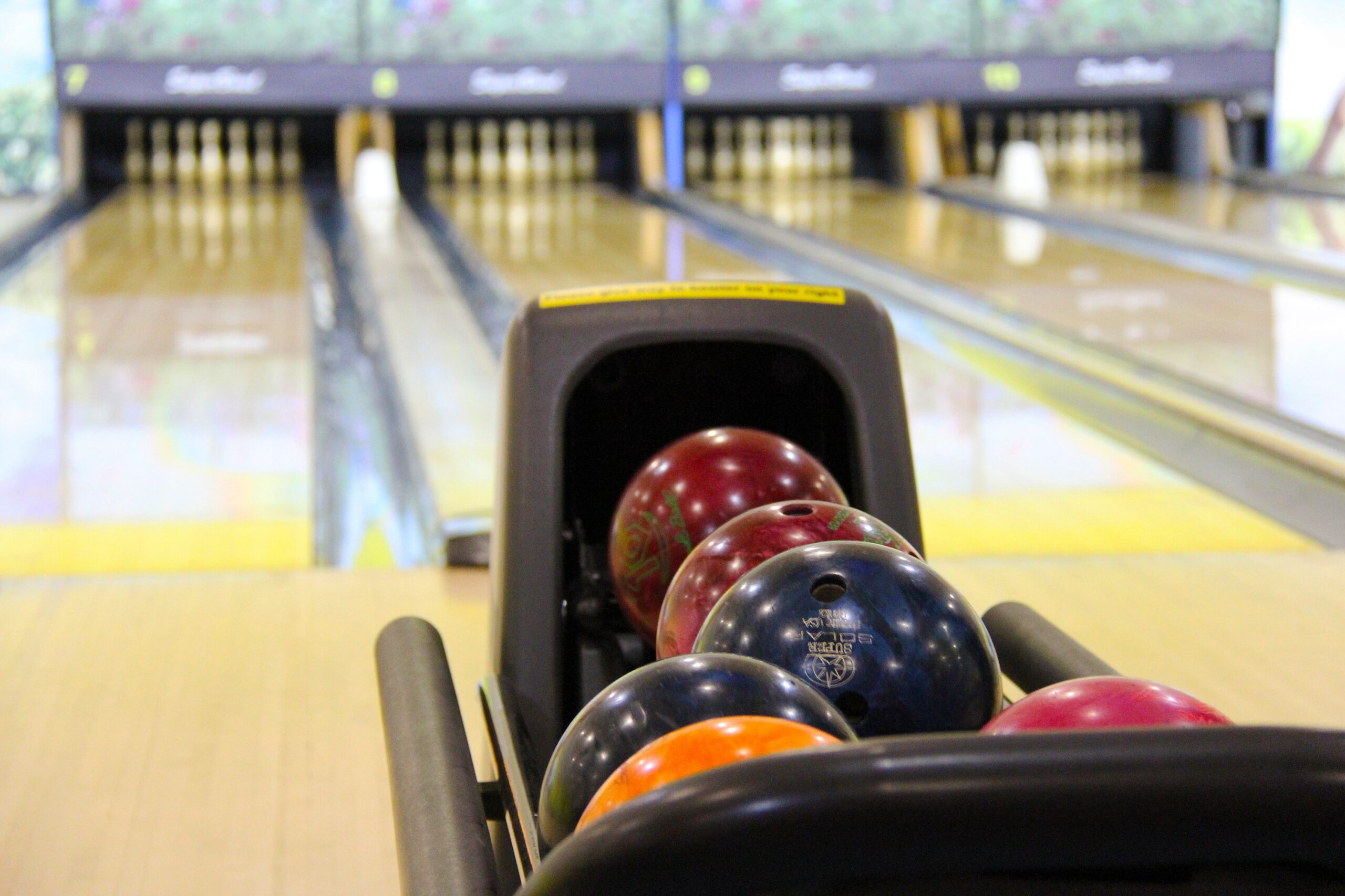 bowling alley lane with multi-colored balls