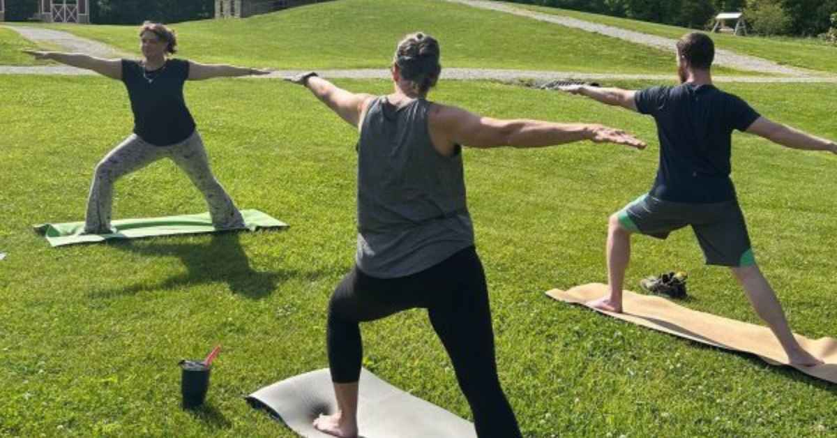 Photo of people doing a yoga pose.