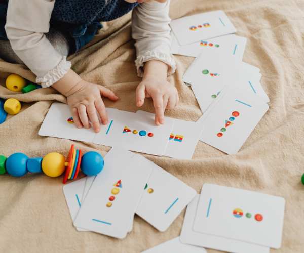 Photo of a child learning shapes and colors on a flash card.