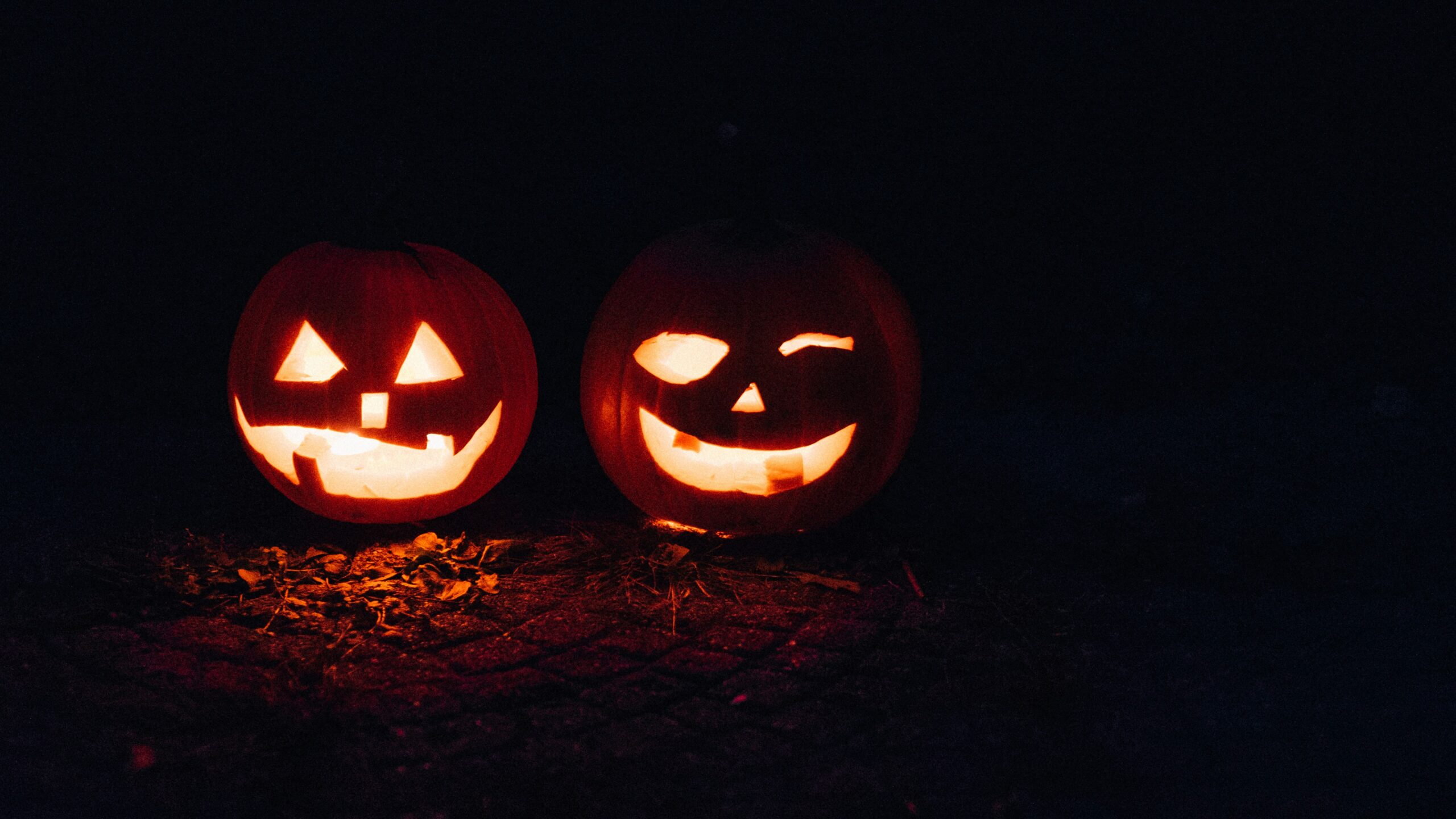 black background with 2 Jacko lanterns glowing