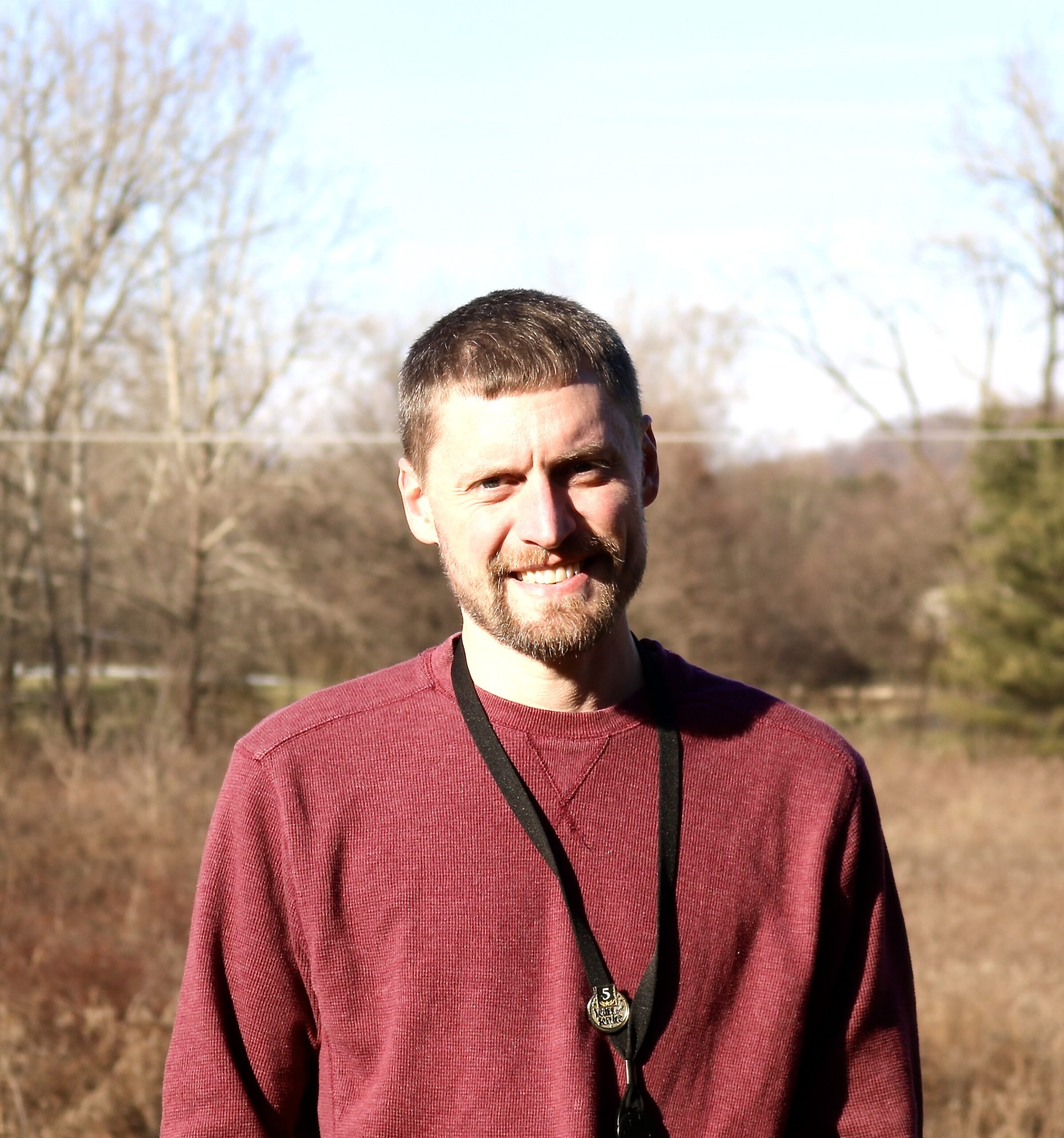 man in a red shirt smiling